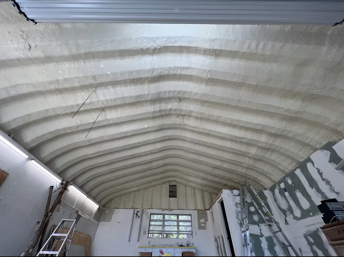 Spray polyurethane foam applied to the underside of a metal roof deck in McPherson
